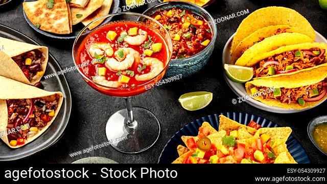 Mexican food panorama on a black background. Shrimp cocktail, chili con carne, tacos, and other dishes