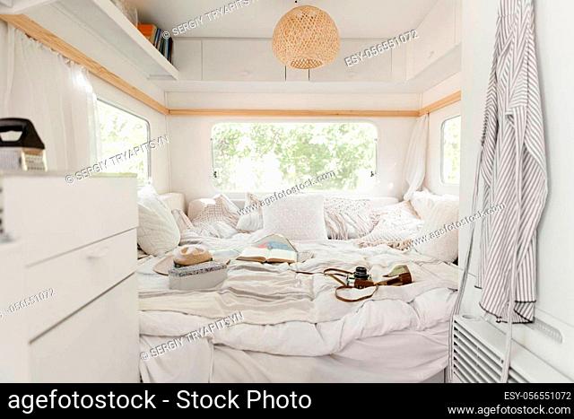 Camping in a trailer, rv bedroom interior, nobody. Travelling on van, romantic vacations on motorhome, camping-car equipment, recreational vehicle