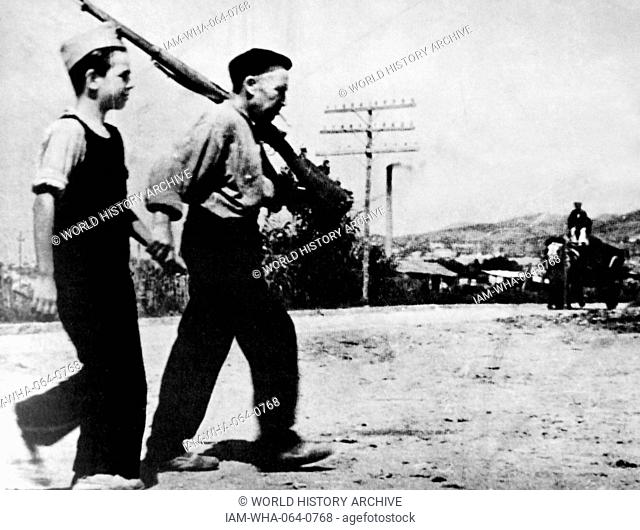 A young boy is drilled for military action in the nationalist forces, during the Spanish Civil War