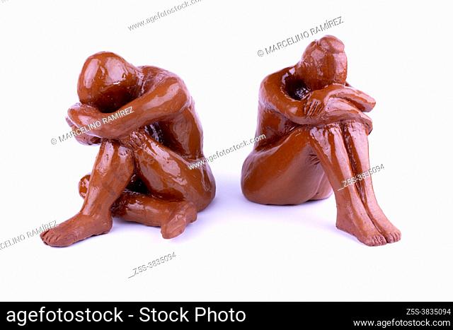 Couple with communication problems. Ceramic figure woman and man. Isolated on white