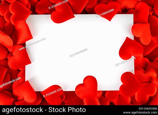 Valentine's day many red silk hearts background , border frame isolated on white with copy space, love concept