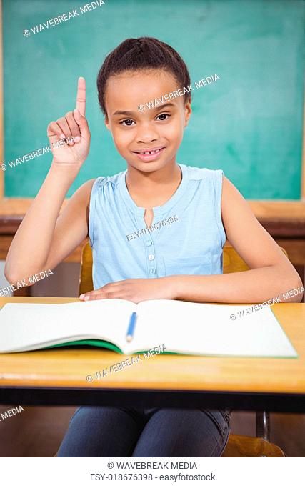Smiling student with a rasied hand