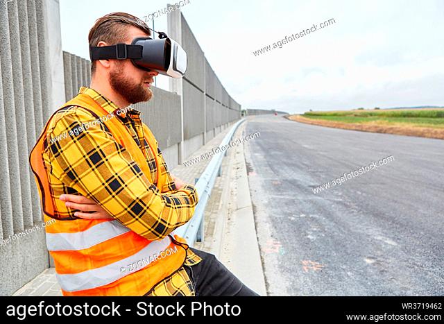 Bauarbeiter mit VR-Brille auf der Baustelle für virtuelle Straßenplanung der Zukunft