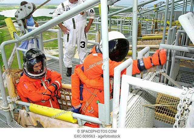 05/17/2002 -- STS-111 Mission Specialist Franklin Chang-Diaz left settles in the seat of the slidewire basket on Launch Pad 39A while Mission Specialist...
