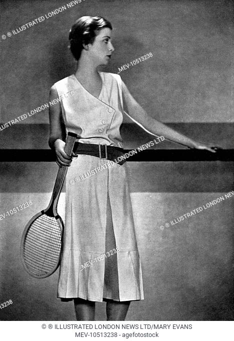 An exclusive Bystander photograph showing the designer, Elsa Schiparelli's practical but stylish jupe-pantalon tennis dress in light white woollen weave with a...