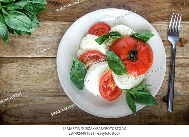 Caprese salad made of tomatoes, mozzarella and basil