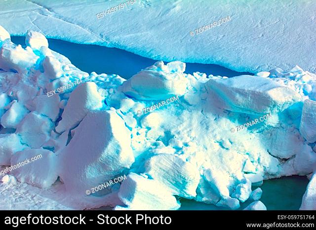 Ice reefing, hummocking. Big old toross intense blue color in cracks in Arctic ocean at latitude 88 degrees, Ice near North pole in 2016