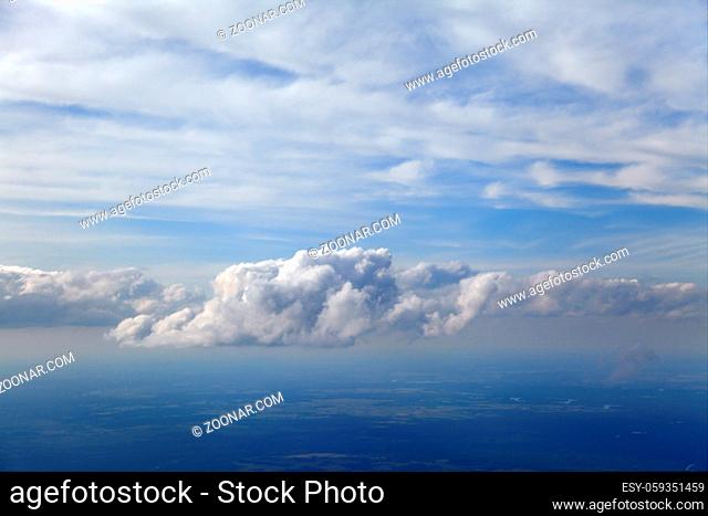 Blue and silver clouds background, view from airplane