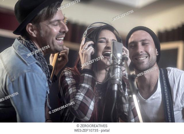 Three singers at recording studio