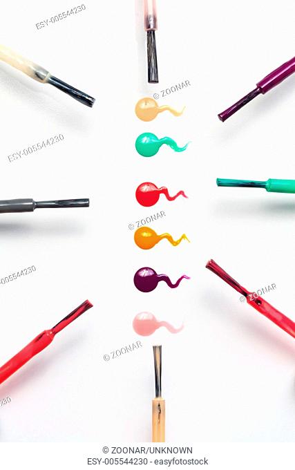 Set of multicolored nail polish brushes and drops