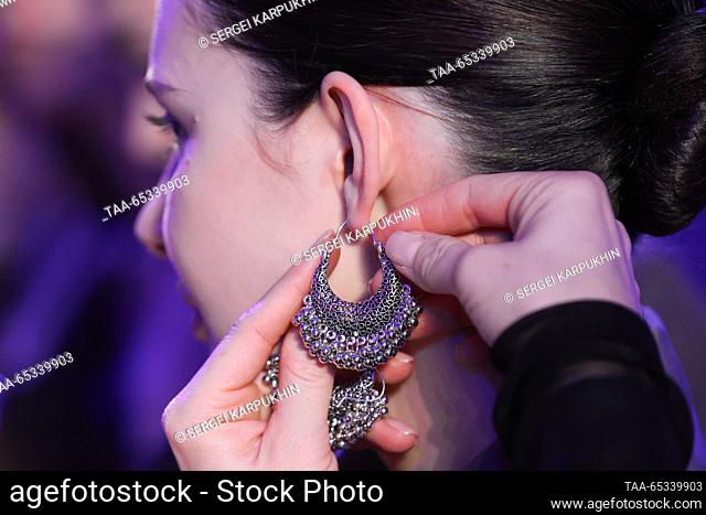 RUSSIA, MOSCOW - NOVEMBER 29, 2023: A model has an earring put on before a catwalk show for the Chinese fashion brand Chnnyu held as part of the BRICS + Fashion...