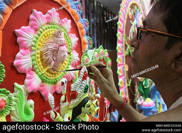 A ceramic artist at work sculpturing Mother Goddess Durga, ahead of the Durga Puja festival. Durga Puja, the annual Hindu festival that involves the worship of...