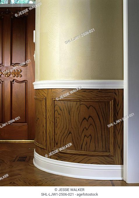 entry hall: detail of foyer with faux wood paneling, white trim and beige wall