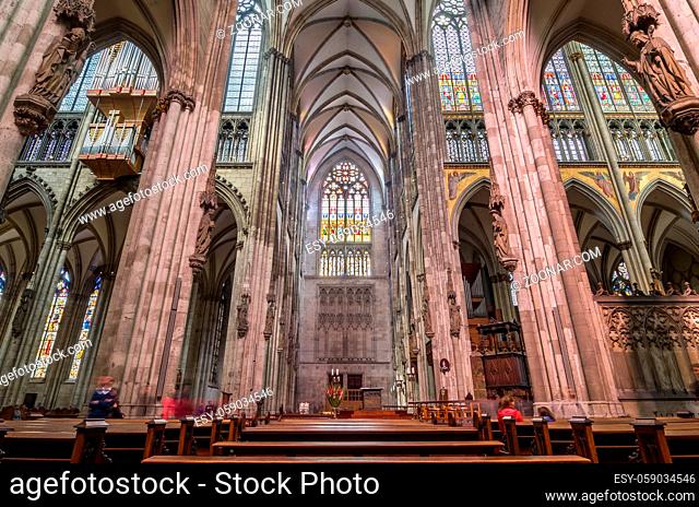 COLOGNE, GERMANY - SEP 17, 2015: Interior of the Cologne Cathedral. Roman Catholic cathedral in gothic style. Nave, ceiling, organ, columns and stained glass