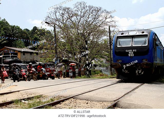 RAILWAY CROSSING & BLUE TRAIN; PERADENIYA, SRI LANKA; 12/03/2013
