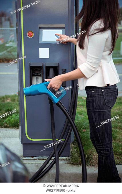 Woman using plug-in electric machine