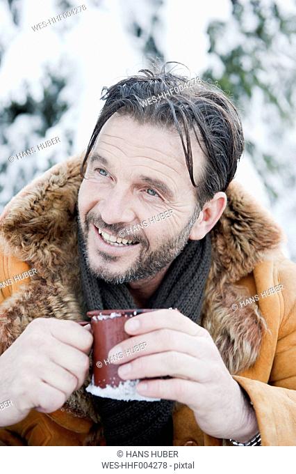 Austria, Salzburg County, Mature man drinking tea, smiling