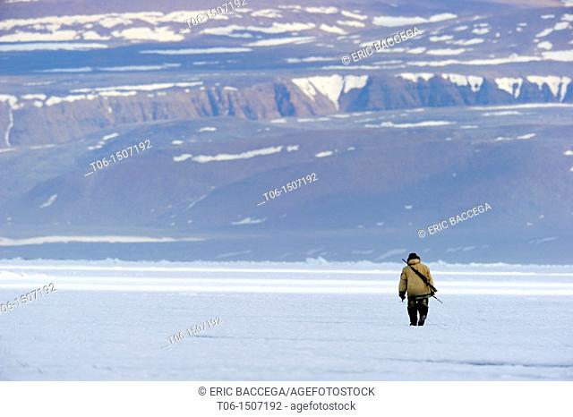 Inuit hunter on icepack, Floe Edge, Arctic Bay, Baffin Island, Nunavut, Canada