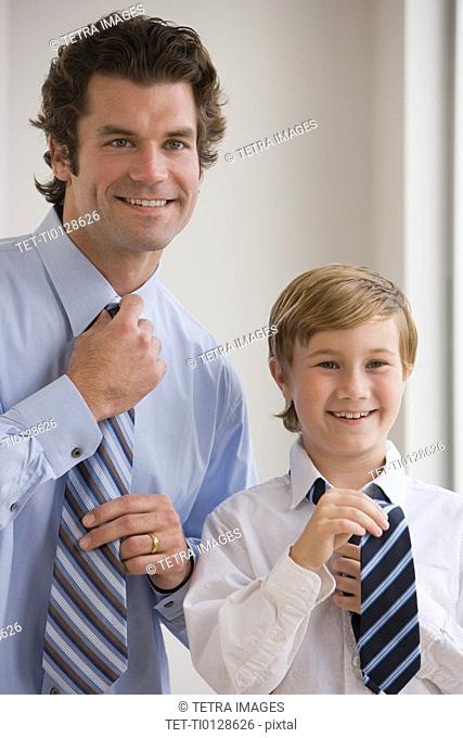 Father and son tying neckties