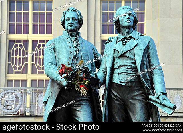 06 October 2021, Thuringia, Weimar: An autumn bouquet decorates the Goethe and Schiller monument on Theaterplatz. The 368th Weimar Onion Market begins on 8...