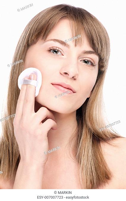 Close-up portrait of young woman with perfect health skin of face and clean sponge. Isolated on white