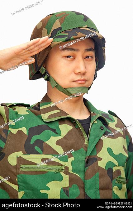 Portrait of man in military uniform saluting