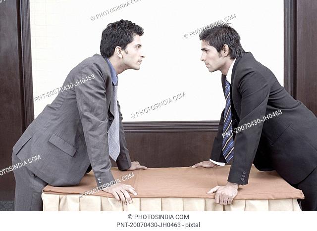 Side profile of two businessmen looking at each other