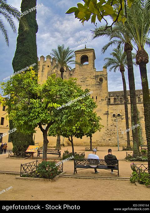 two men on a park bench, Alcazar Reyes Cristianos museum, Cordoba, Andalusia, Spain