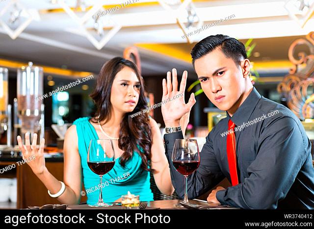 Asian Couple quarelling in restaurant