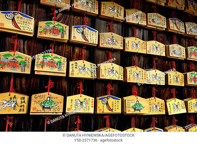 Ema - small wooden plaques on which Shinto worshippers write their wishes, then left them hanging up at the shrine, where the kami spirits or gods receive them