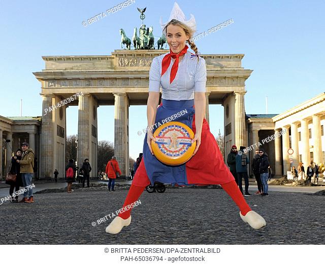 Dutch cheese queen Floor Schothorst poses as Dutch advertising character 'Frau Antje' (Mrs. Antje) holding a cheese wheel in her hands and wearing a...