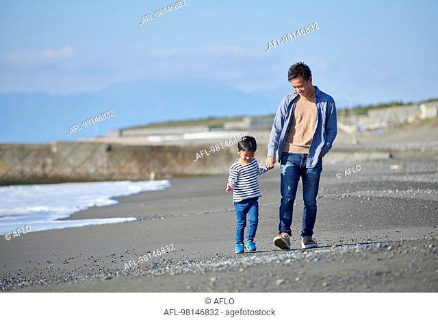 Japanese kid with father at the beach