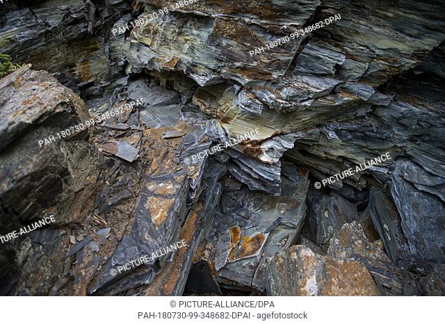 27 July 2018, Germany, Lehesten: Slate in the former opencast mine of the Lehesten Slate Park. The economic basis of the city was slate mining until its end in...