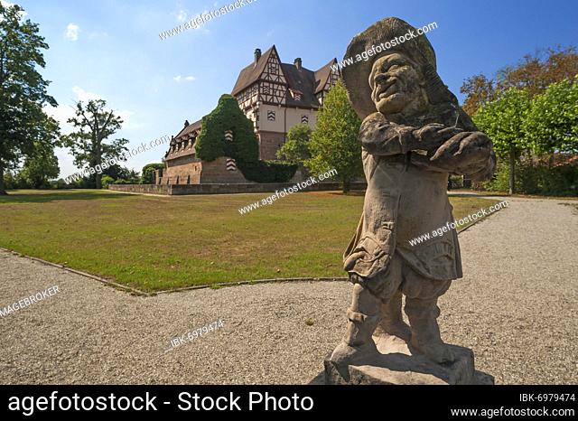 Grotesque gnome of the Baroque in the park, in the back the Neunhofer Jagdschlösschen, 1479, reconstructed in 1964 and 1978/79, Neunhof near Nuremberg