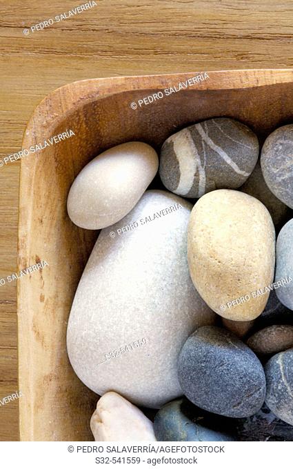 Wooden bowl filled with stones