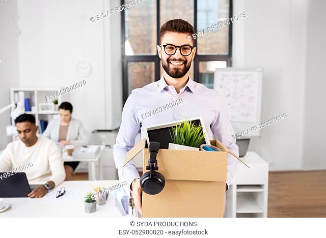 happy male office worker with personal stuff