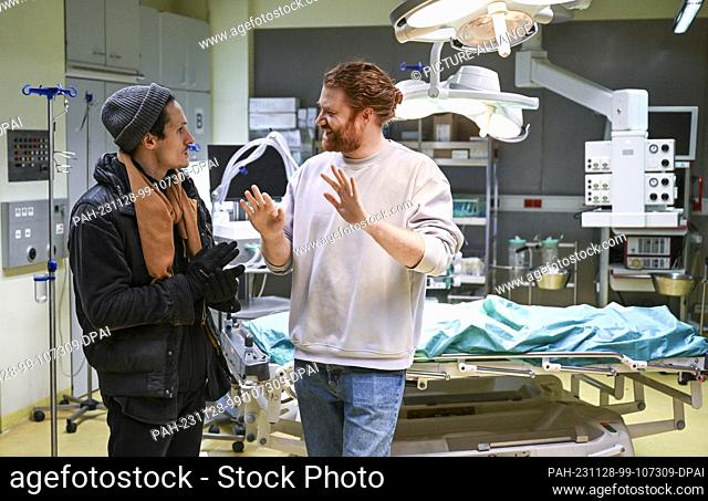 28 November 2023, Berlin: Director Alex Schaad (l) and actor Adrian Tafreshian filming the medical series ""KraNK"" at the former Sports and Recreation Center...