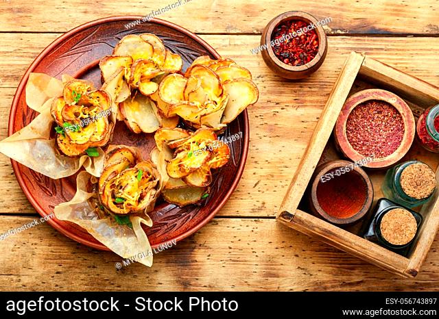 Fried potato with bacon on plate over wooden table