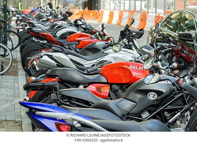Ducati motorcycles and other brands are lined up in front of the Ducati dealership in the Soho neighborhood of New York