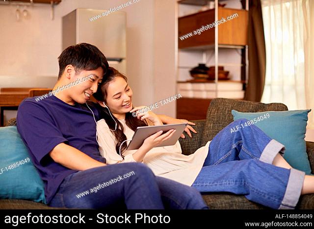 Young Japanese couple at home