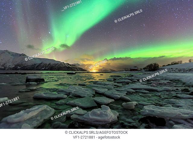 The Northern Lights illuminates the icy landscape in Svensby Lyngen Alps Tromsø Lapland Norway Europe