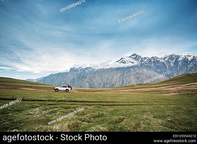 White SUV Car On Off Road In Spring Mountains Landscape. Drive And Travel Concept. Landscape Of Gorge At Spring Season
