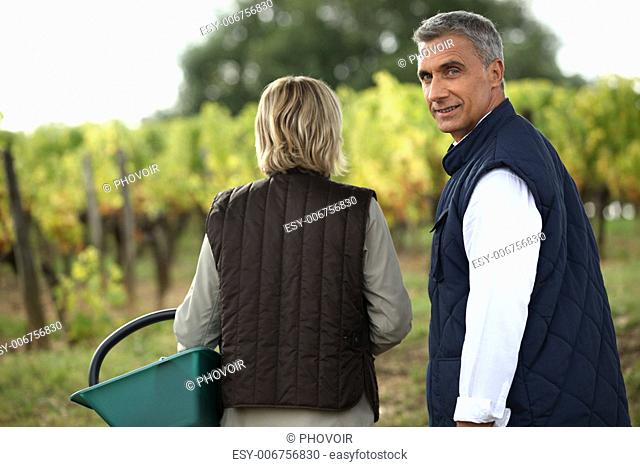 Couple tasting wine in the vineyard