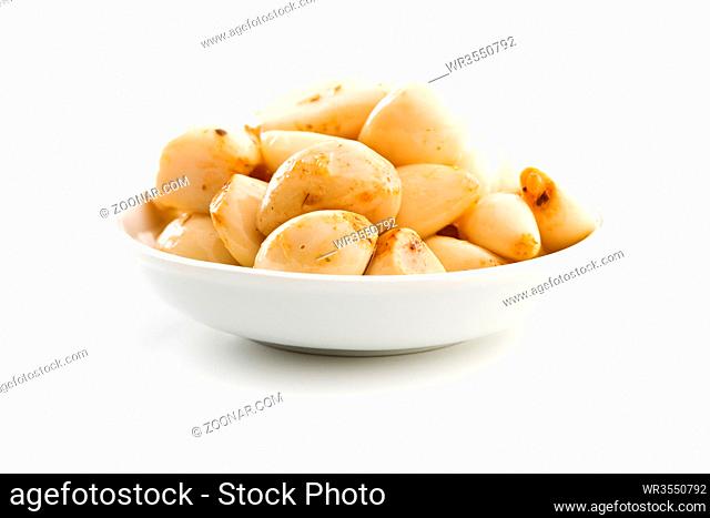 Marinated garlic. Pickled garlic in bowl isolated on white background