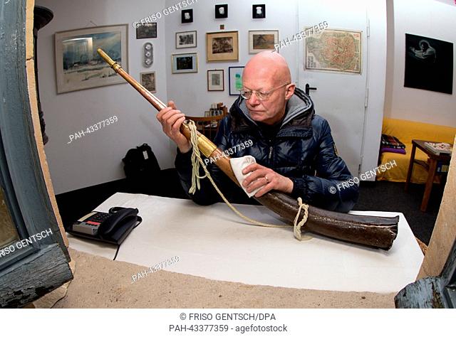 Watchman Wolfram Schulze polishes his horn at the Lamberti Church in Muenster, Germany, 15 October 2013. The city of Muenster is looking for a replacement per...