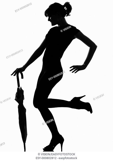 full length silhouette in shadow of a young woman with closed umbrella in studio on white background isolated