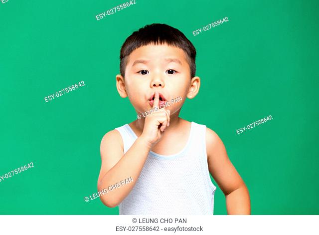 Little boy making a gesture for keeping quiet