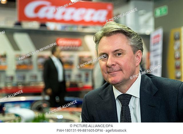 Andreas Stadlbauer, CEO of the Austrian company 'Stadlbauer Marketing und Vertrieb' (lit. Stadlbauer Marketing and Sales) sits next to a Carrera racetrack at...