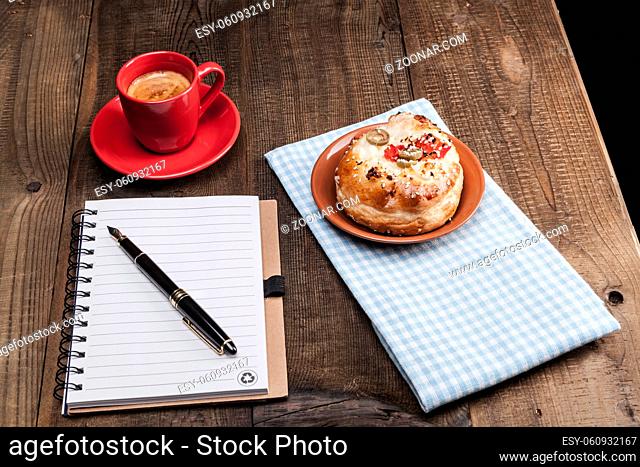 Coffee in red cup and food on wood table