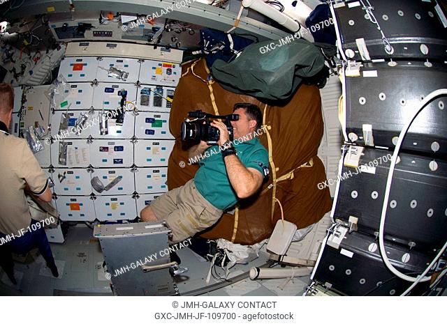 Astronaut Steve Bowen, STS-126 mission specialist, uses a video camera on the middeck of Space Shuttle Endeavour while docked with the International Space...